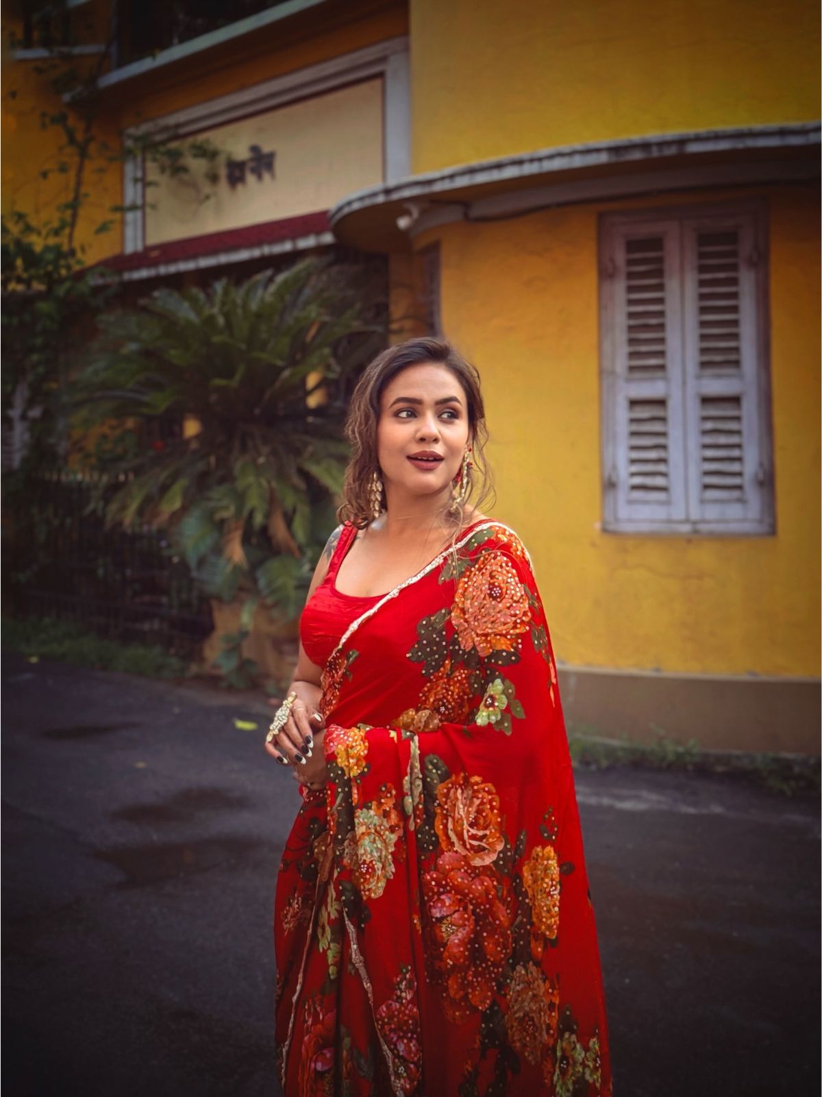 Model wearing red chinon chiffon saree with digital print and handwork